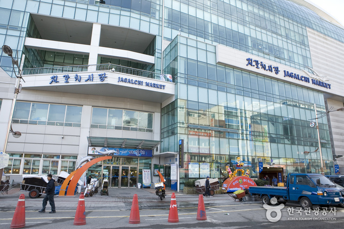 부산 자갈치시장 건물 외관과 자갈치시장 표지판이 보이는 장면