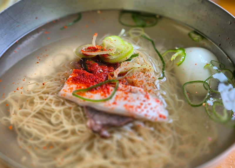 서울 충무로 필동면옥 평양냉면 국물과 면, 고명이 가까이 보이는 모습