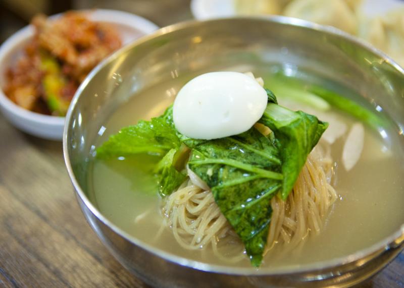 평래옥 차가운 육수 냉면 한 그릇 위에 달걀과 채소 고명이 올라간 모습
