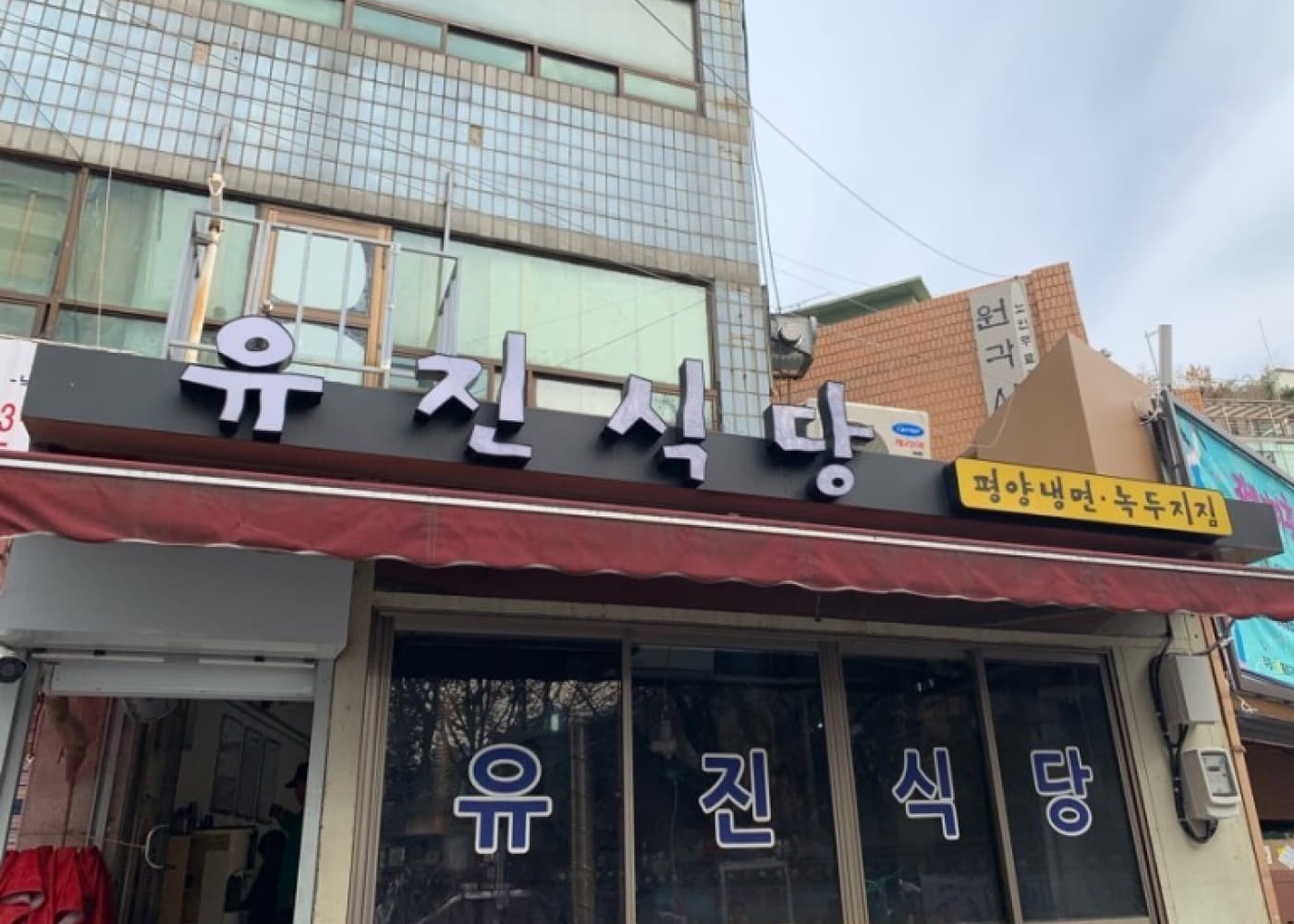서울 종로3가 유진식당 검은 간판과 붉은 차양이 보이는 외관 전경